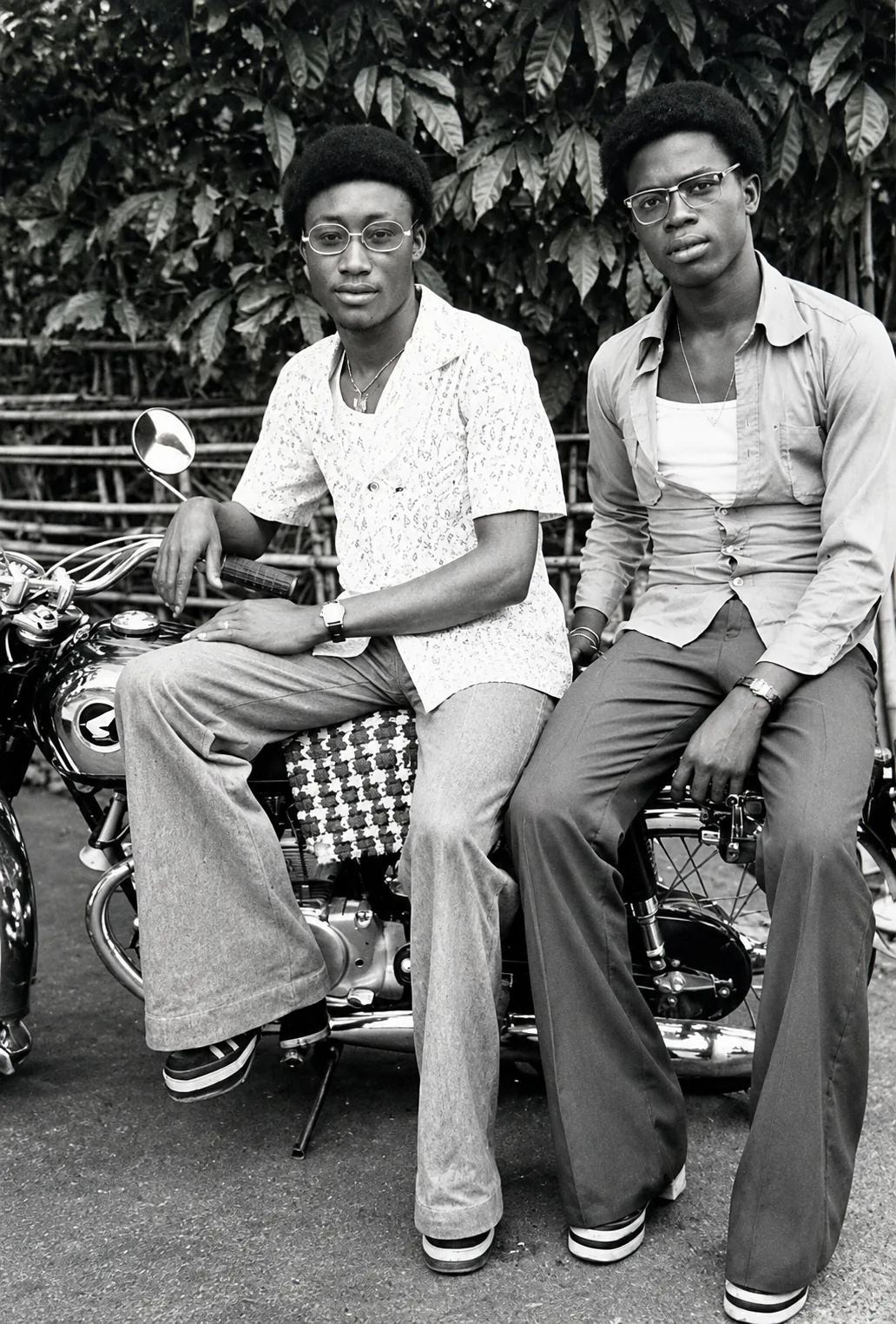 Two men posing on a motorcycle